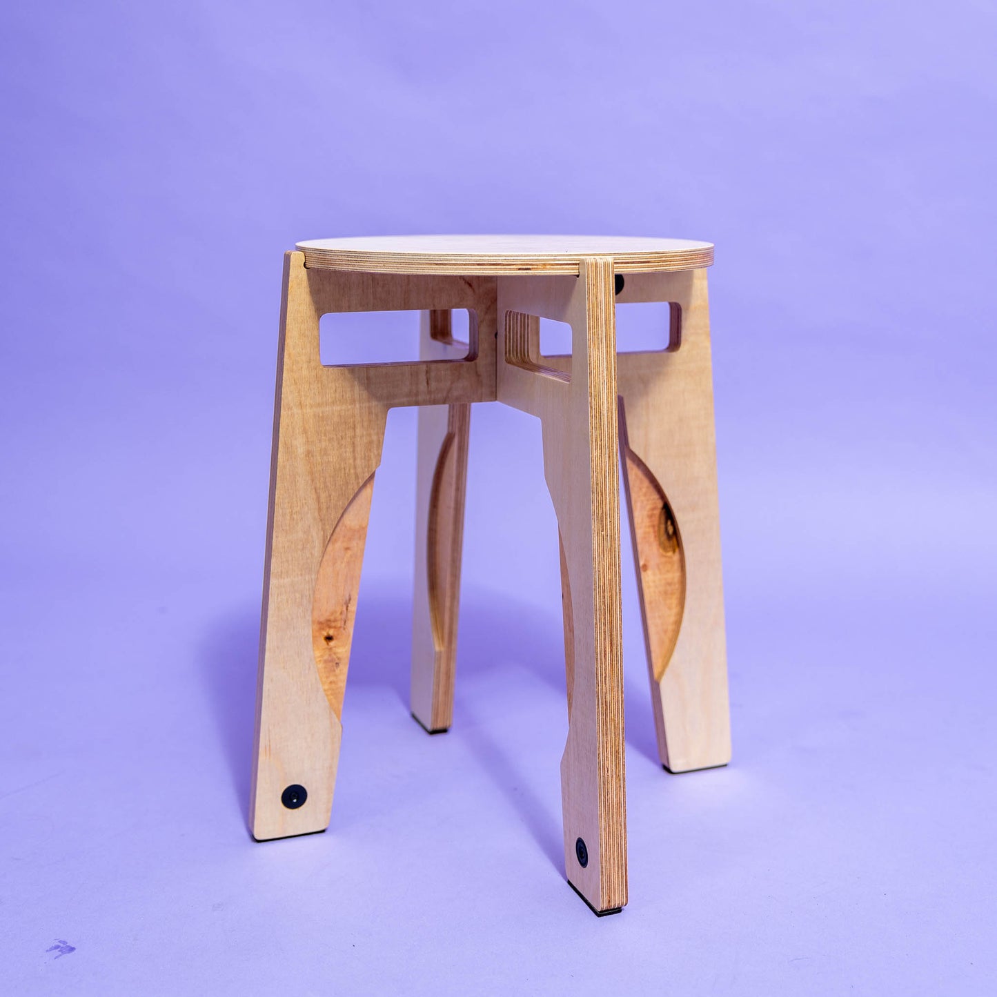 Designerhocker Produktfotografie vor lila Hintergrund zusammengebaut